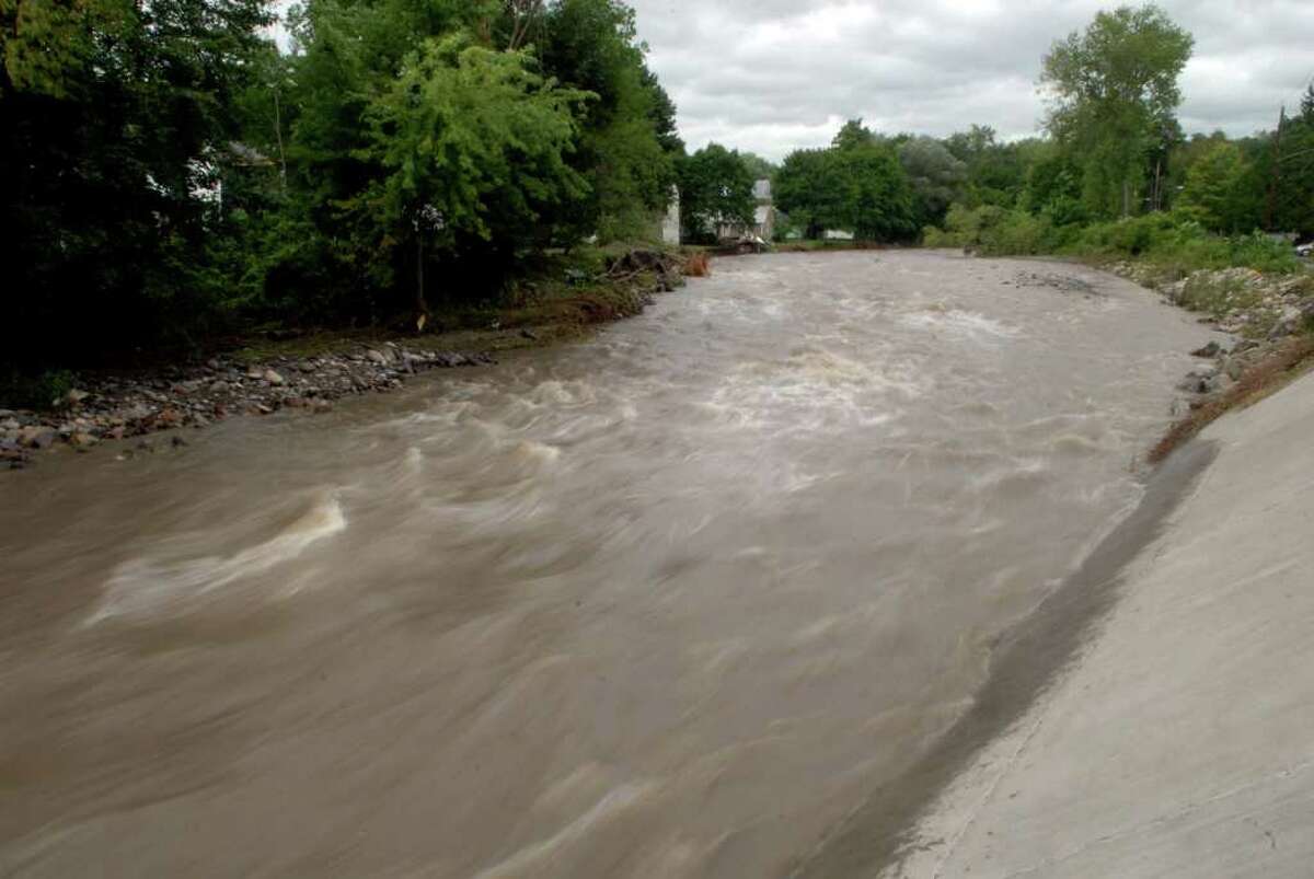 Water rushes along the Otsquago Creek in Fort Plain on Monday, Aug. 23, 2010. Heavy rain on Sunday night caused the Otsquago Creek to rise up and over its banks. (Paul Buckowski / Times Union)