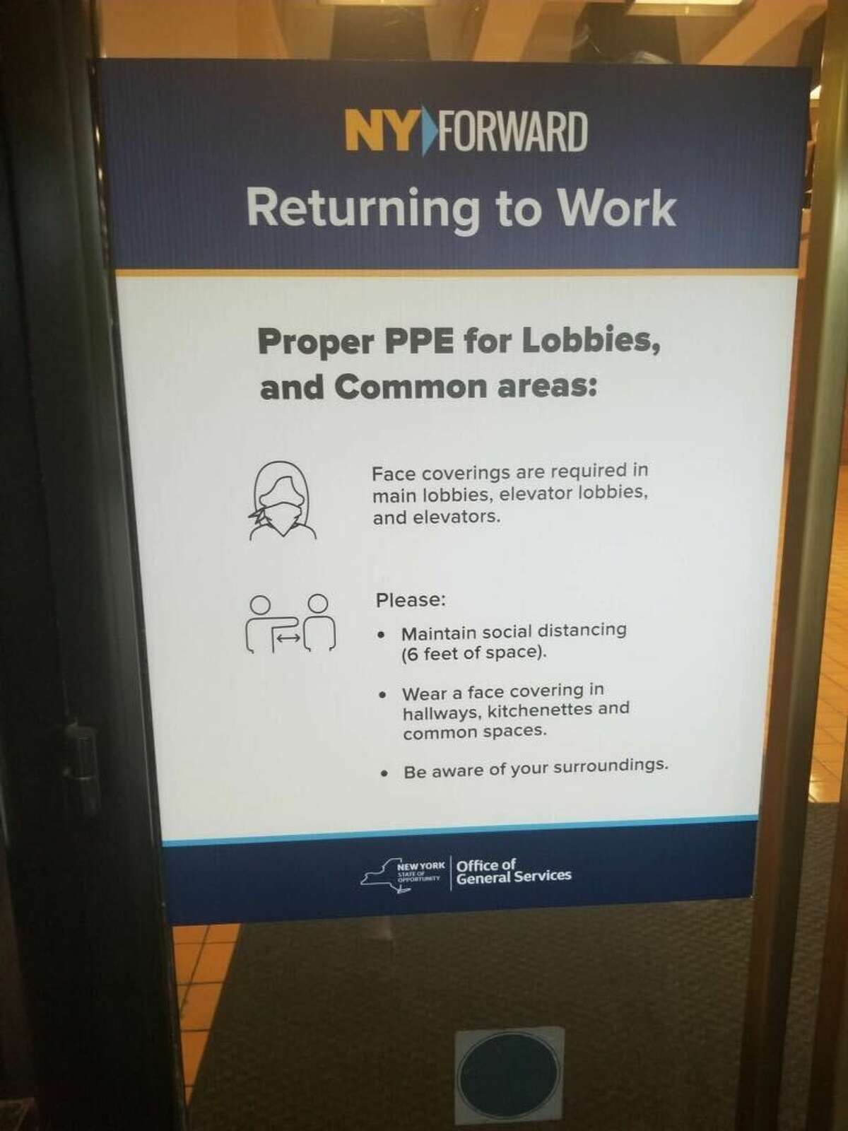 A sign is posted in the Swan Street building as state employees return to offices. (Submitted photo)