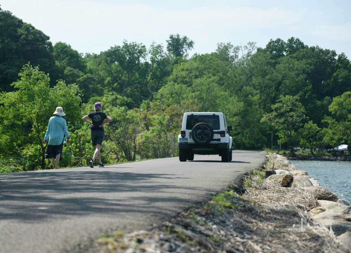 Pedestrians walk down a stretch of Tod’s Driftway at Greenwich Point Park in Old Greenwich, Conn. Wednesday, June 10, 2020.