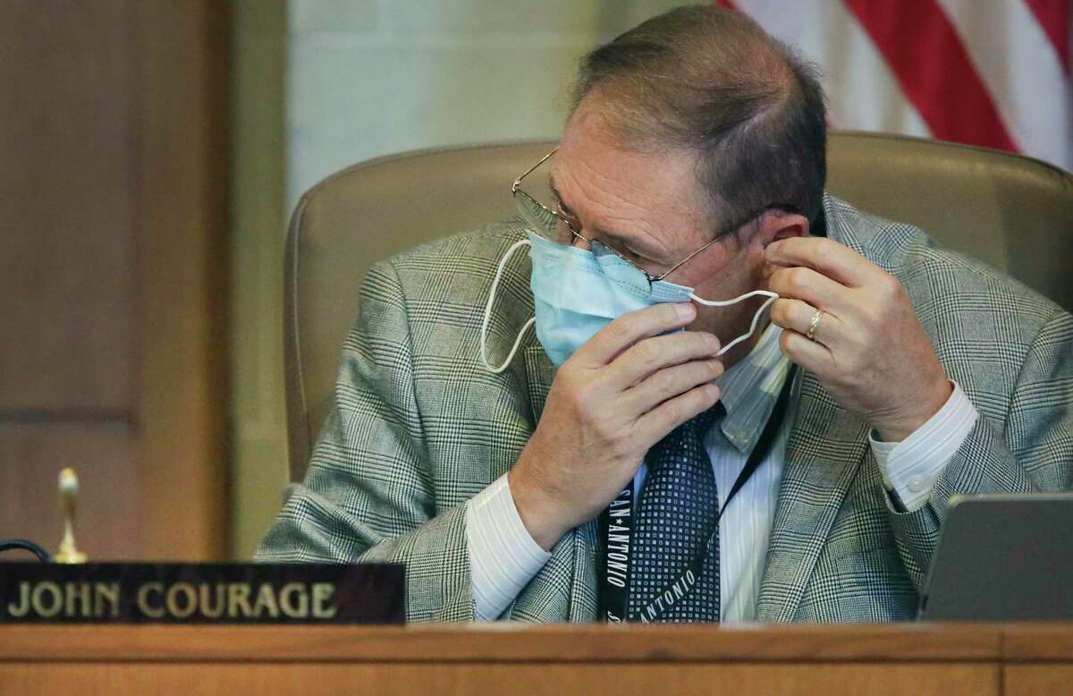 City Council member John Courage puts his mask on at the beginning of the San Antonio City Council meeting at the Municipal Plaza Building on Thursday, June, 11, 2020.