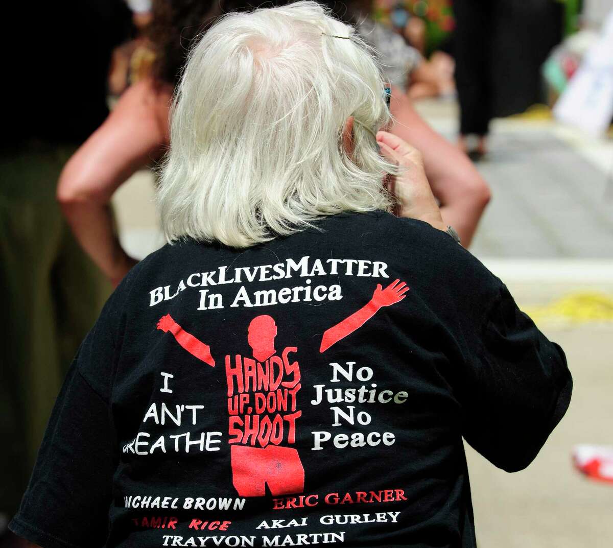 A protester listens to speakers during a rally outside Greenwich Town Hall on June 6. More than 600 protesters gathered peacefully to protest the senseless death of George Floyd and call for police reform.