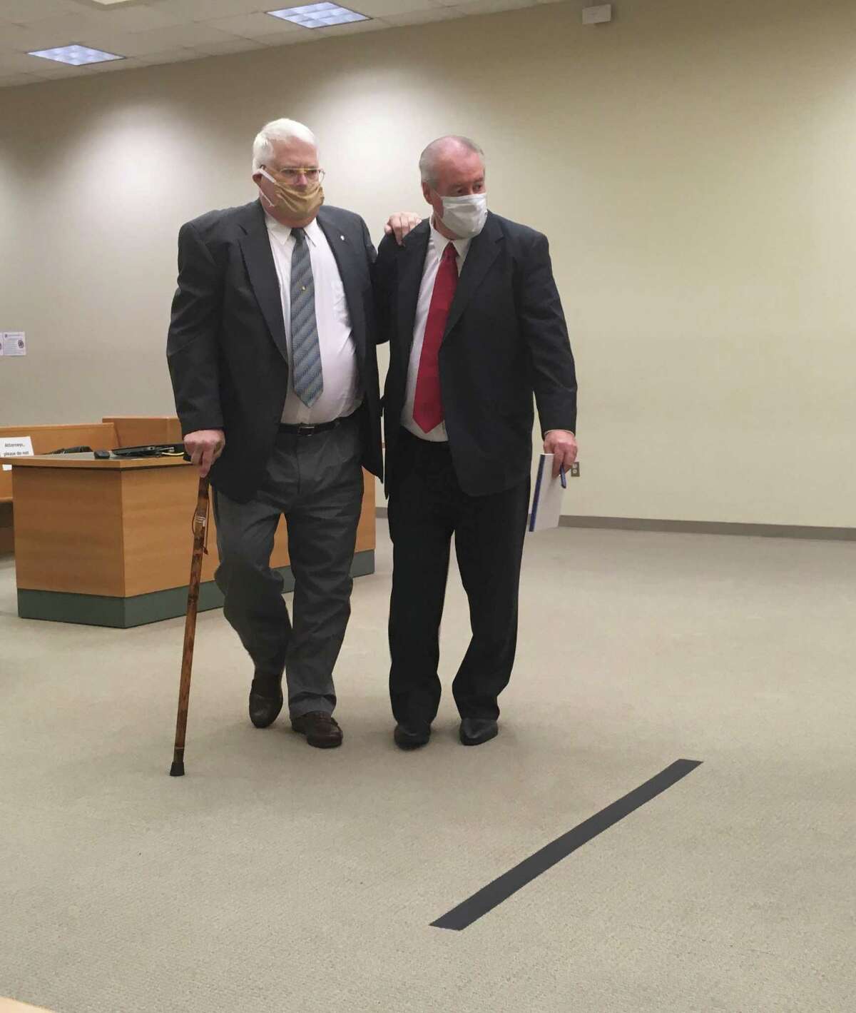 Richard Commaille, 70, left, is led by his attorney Edward Gavin, right, to appear in Waterbury Superior Court on June 10, 2020.