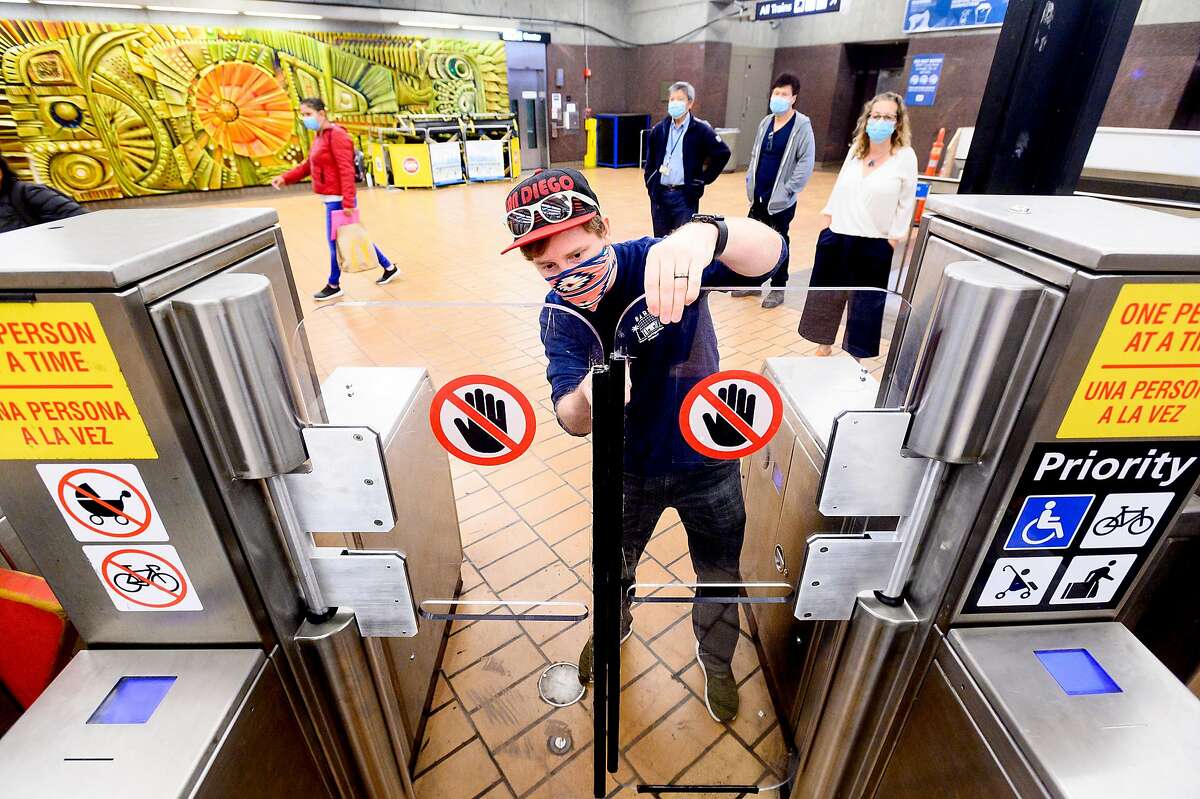 BART computer systems engineer Evan Brown fine tunes a tolerances on a prototype fare gate at BART's Richmond Station on Thursday, June 11, 2020, in Richmond, Calif. The prototype includes two five foot barriers designed to reduce fare evasion.