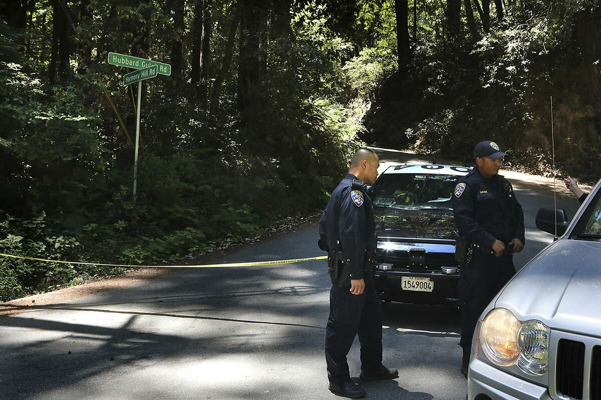California Highway Patrol officers keep a road closed in Ben Lomond near Santa Cruz, Calif., Monday, June 8, 2020, as FBI agents continue processing the scene where Santa Cruz County Sheriff's Sgt. Damon Gutzwiller was killed Saturday. An active-duty U.S. Air Force sergeant accused of killing Gutzwiller in an ambush-style attack was a leader for a military base's elite security force, officials said Monday. Staff Sgt. Steven Carrillo has been arrested on suspicion of fatally shooting Gutzwiller and wounding two other officers Saturday. He is expected to be charged with first-degree murder. (Shmuel Thaler/The Santa Cruz Sentinel via AP)