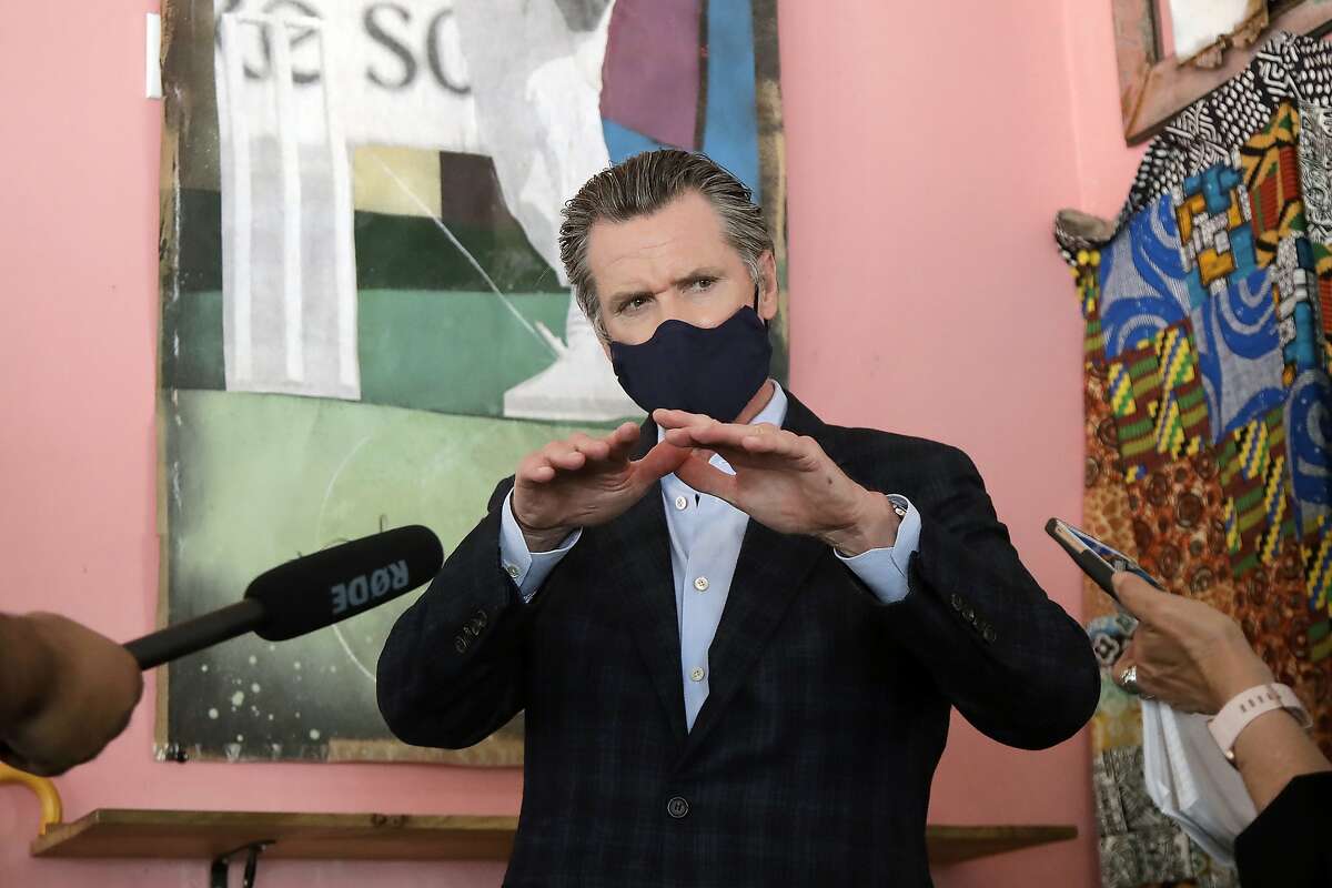 Gov. Gavin Newsom wears a protective mask on his face while speaking to reporters at Miss Ollie's restaurant during the coronavirus outbreak in Oakland, Calif., Tuesday, June 9, 2020. (AP Photo/Jeff Chiu, Pool)