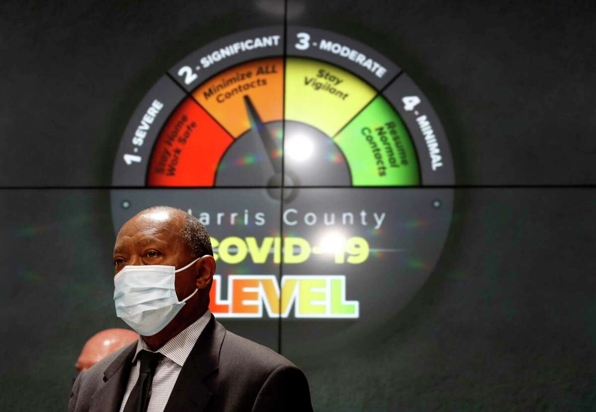 Houston Mayor Sylvester Turner listens to Harris County Judge Lina Hidalgo speak at a press conference to announce that Harris County had reached level two-orange due to the increase in the number of coronavirus cases accounted for in the last days at Transtar, Thursday, June 11, 2020.