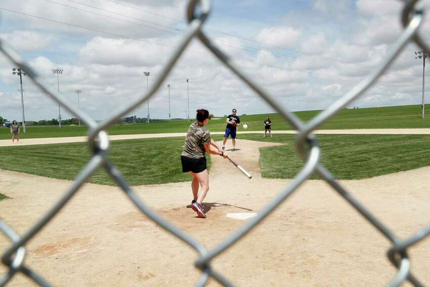 Visitors play on the field at the Field of Dreams movie site, Friday, June 5, 2020, in Dyersville, Iowa. Major League Baseball is building another field a few hundred yards down a corn-lined path from the famous movie site in eastern Iowa but unlike the original, it's unclear whether teams will show up for a game this time as the league and its players struggle to agree on plans for a coronavirus-shortened season. (AP Photo/Charlie Neibergall)