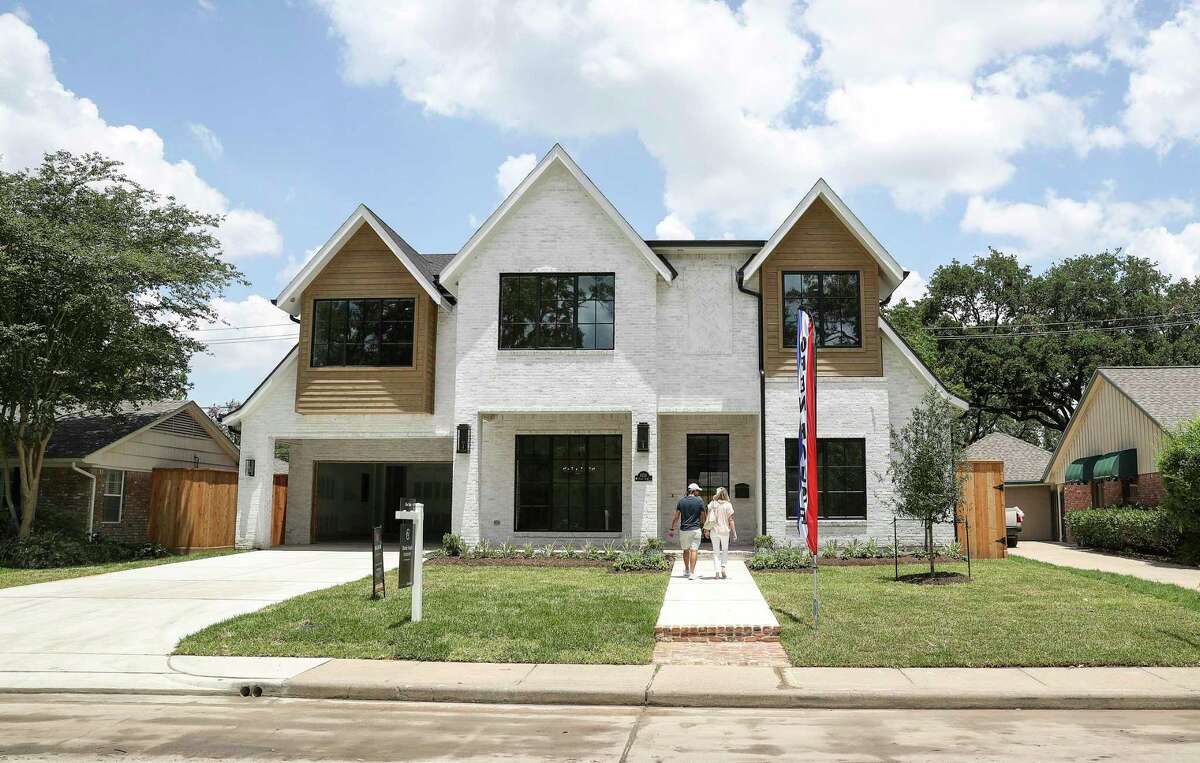 A couple walks in to an open house Thursday, June 4, 2020, in the Briargrove neighborhood in Houston.