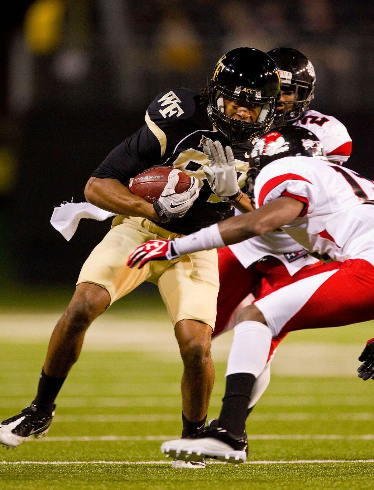 WINSTON SALEM, NC - SEPTEMBER 17: Matt James #87 of the Wake Forest Demon Deacons braces for a hit from Kamar Morrison #13 of the Gardner-Webb Bulldogs at BB&T Field on September 17, 2011 in Winston Salem, North Carolina. The Demon Deacons defeated the Runnin' Bulldogs 48-5. (Photo by Brian A. Westerholt/Getty Images)