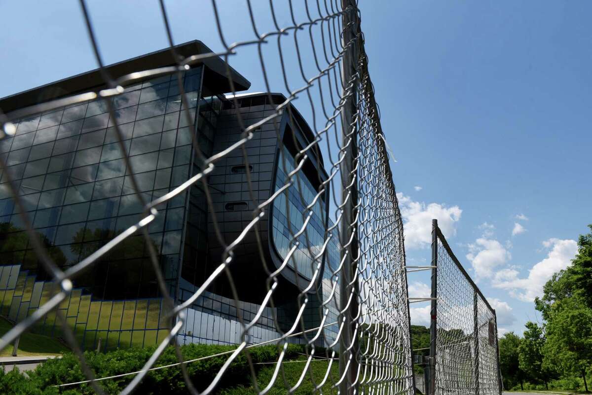 The Experimental Media and Performing Arts Center at Rensselaer Polytechnic Institute is fenced off from the street and lower windows are covered for protection on Friday, June 12, 2020, in Troy, N.Y. (Will Waldron/Times Union)