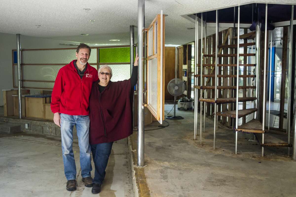 Carol and Leonard Bogan pose or a portrait Friday morning in their home on W. Sugnet Road, which was flooded with several feet of water. The dome-shaped structure was designed by Robert E. Shwartz in the mid-century modern style, and construction began in 1964. (Katy Kildee/kkildee@mdn.net)
