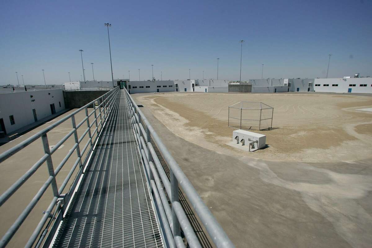 PRISONS_052_MJM.jpg The prison is divided into four sections, each identical to the other to keep the population segregated. This is a view of one of the sections with the cell blocks surrounding a yet to be landscaped exercise yard. The Kern Valley State Prison just north of Bakersfield opened in June at a total cost of $716 million. It was described as the last California prison needed after a two decade long, $4.5 billion building boom. But officials now concede it will barely make a dent in the system's massive overcrowding. There are currently less than 70 inmates housed here but by January 2006, the prison will hold it's maximum capacity of 5,000 prisoners. Photo by Michael Maloney / San Francisco Chronicle