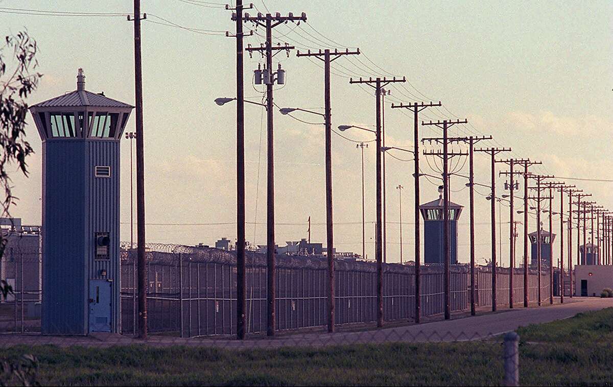 Guard towers line the perimeter of Corcoran State Prison as seen from the street Thursday, Feb. 26, 1998 in Corcoran, Calif. A federal grand jury accused eight Corcoran State Prison officers of pitting inmates in deadly gladiator style fights for the guard's amusement. (AP Photo/Eric Paul Zamora)