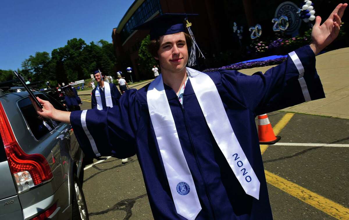 Class of 2020 graduates including Jack Burg join in a motorcade to Staples High School for a drive-through commencement ceremony Friday, June 12, 2020, in Westport, Conn. “The way this has all come together says a lot to the Staples community,” Thomas said. “It’s fantastic.” A graduation committee worked for a month to put together the ceremony, he said. After Gov. Ned Lamont issued an executive order allowing gatherings of 25 people, they were able to craft a celebration by adding the stage, allowing students to get out of their cars and have their graduation walk.