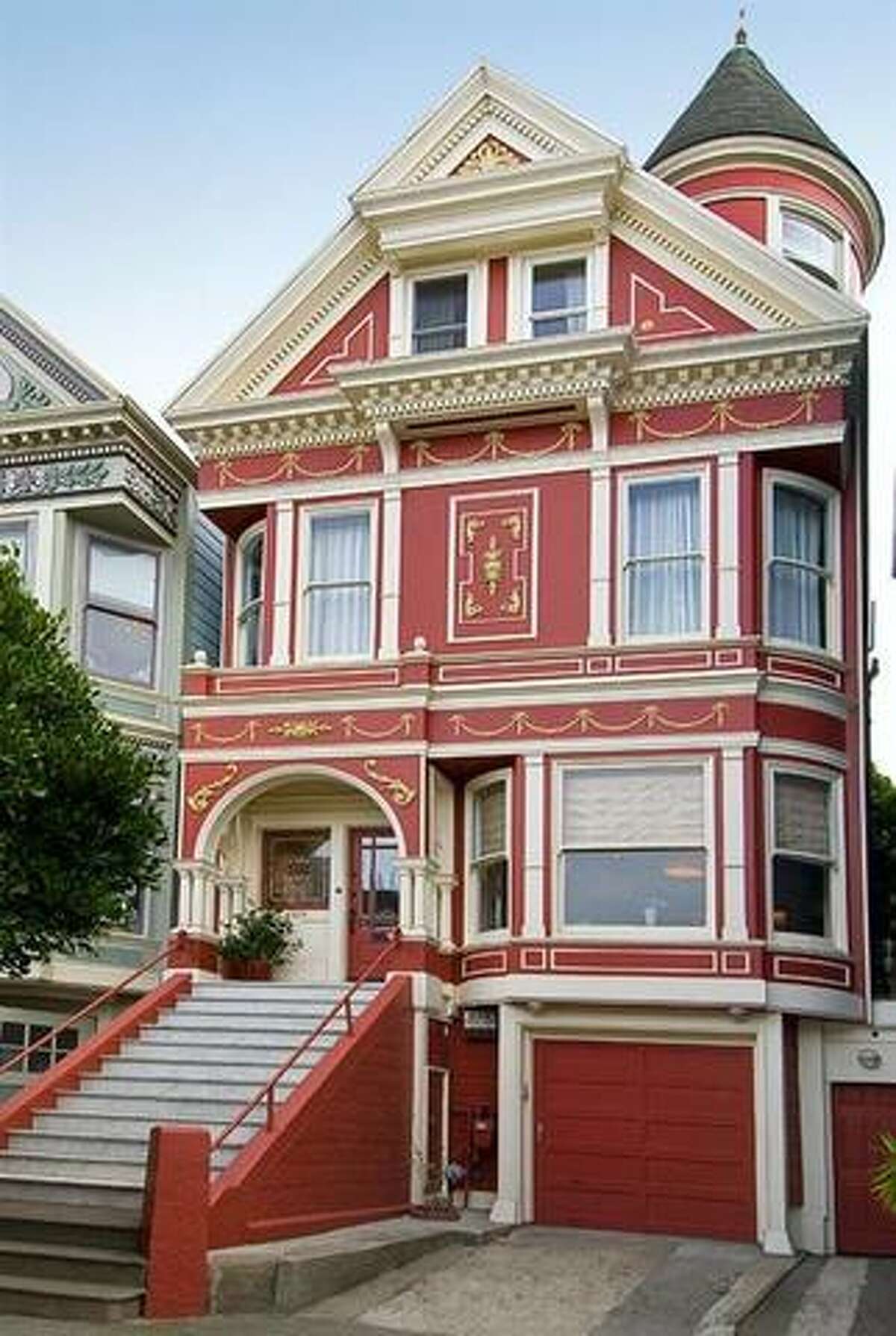 The "Fall" home, two doors down at 1333 Waller, is finished in a deep red and gold, and embellished with leaves. This five-bedroom, 2.5-bathroom home last sold for $1,725,000 in June 2009. The house was damaged by a fire in 2013 but survived the blaze.