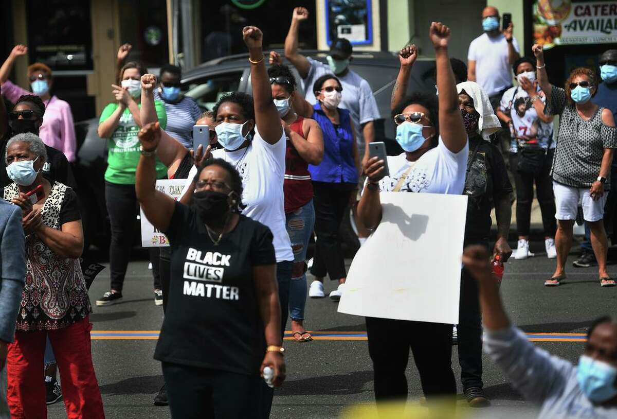 A chant of "Black Lives Matter" in response to national incidents of police brutality is lead by Valley NAACP head Greg Johnson during a gathering of local ministers, political leaders and residents outside City Hall on Main Street in Ansonia, Conn. on Thursday, June 4, 2020.