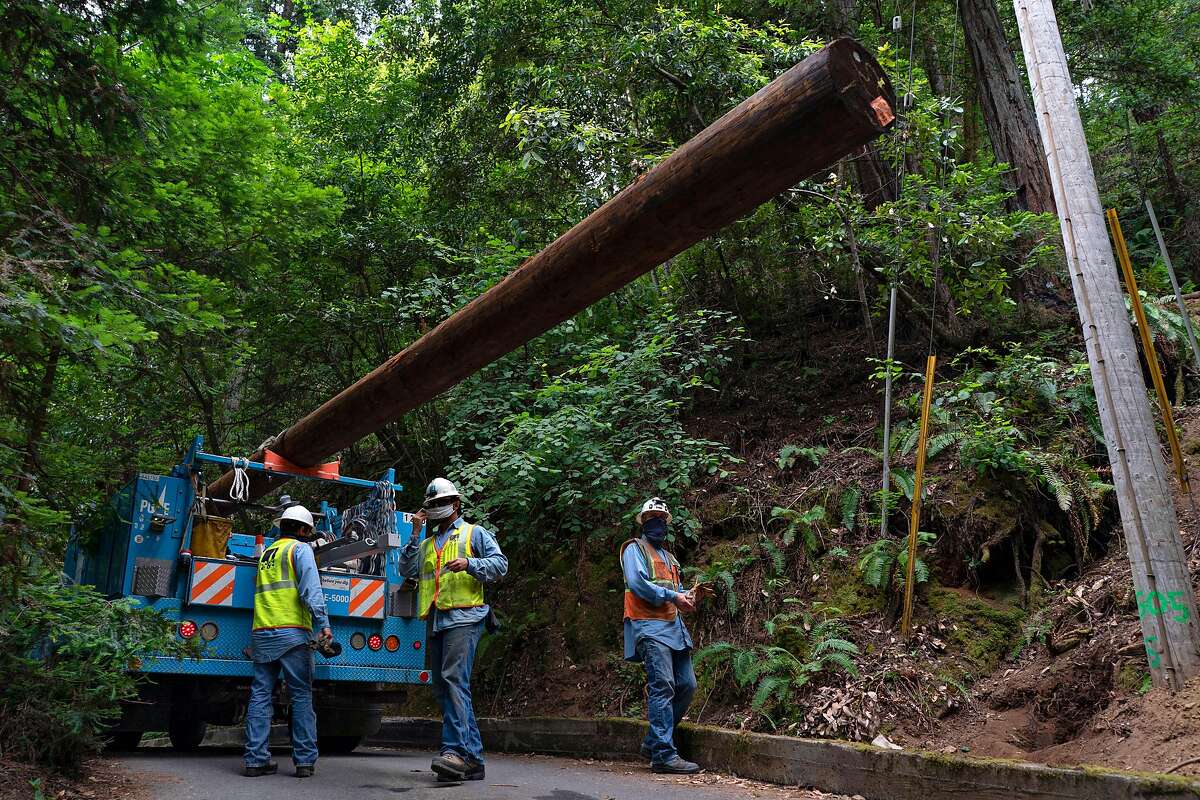 A PG&E crew replaces older wood power poles at Odd Fellows Park with more resilient ones that are less likely to become broken during windstorms and cause wildfires. Guerneville, California on June 12, 2020.
