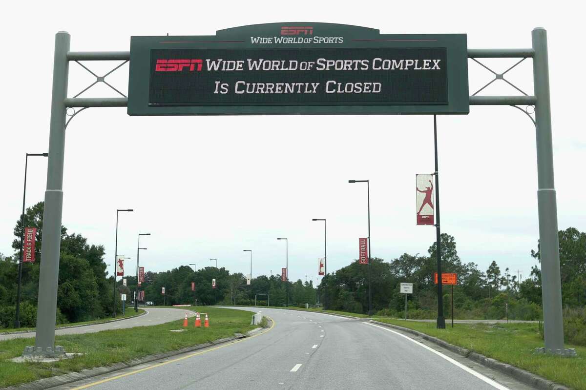 A sign at the entrance to ESPN's Wide World of Sports at Walt Disney World is seen Wednesday, June 3, 2020, in Kissimmee, Fla. The NBA has told the National Basketball Players Association that it will present a 22-team plan for restarting the season at Disney. (AP Photo/John Raoux)
