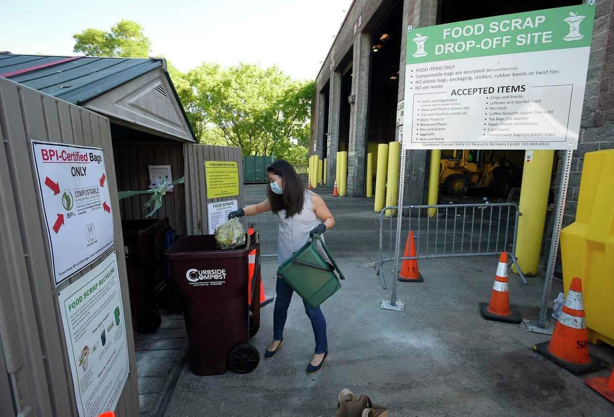 Greenwich resident Kanako MacLennan drops off food waste at the town's Holly Hill Transfer Station on June 12, 2020 in Greenwich, Connecticut. The new food scrap recycling program "Composting Material for Greenwich", turning food waste into compost, adding Greenwich to a growing list of lower Fairfield County more stainable Green communities.