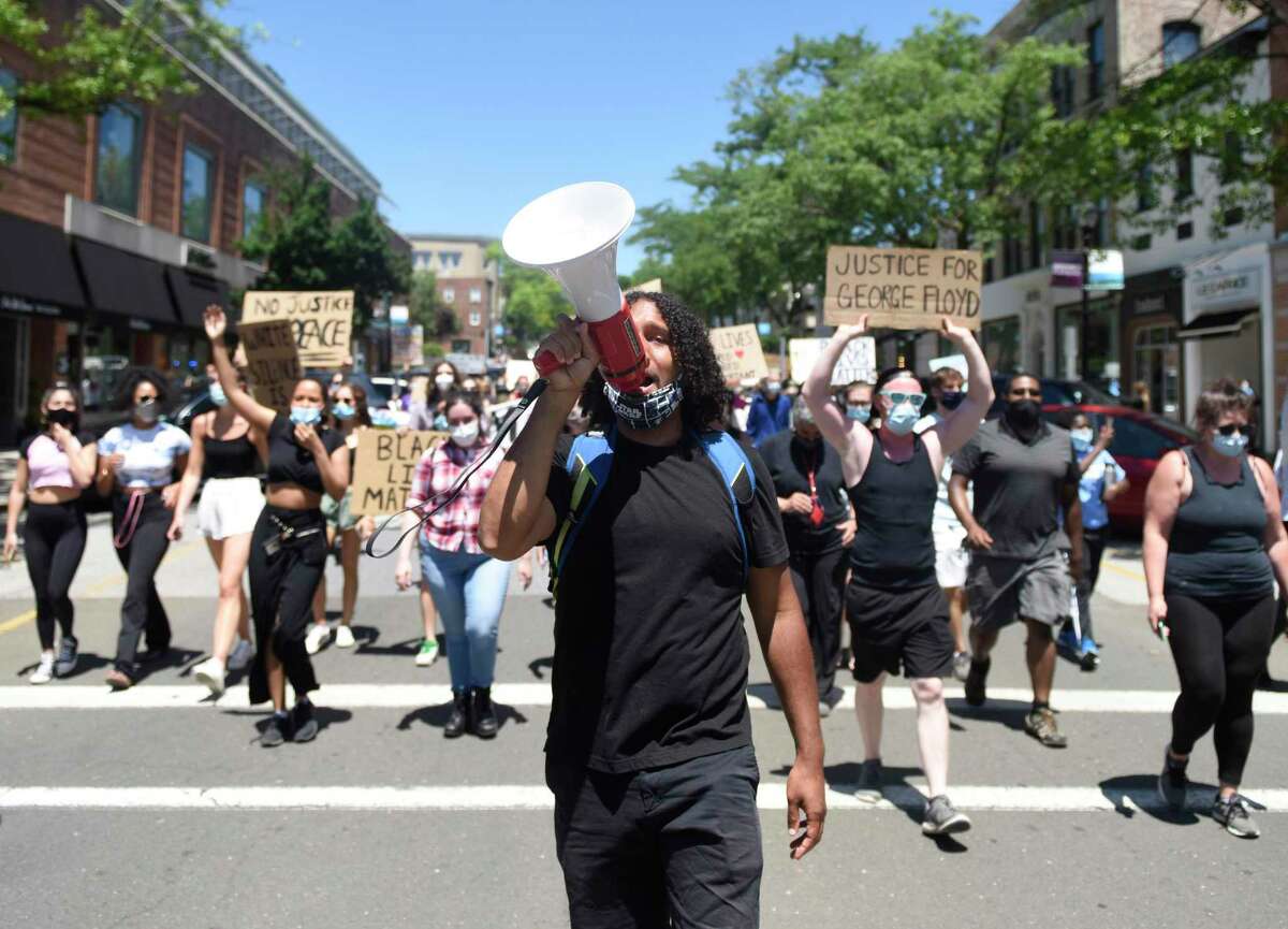 Norwalk's Elijah Manning leads the Black Lives Matter Wake Up March from Town Hall to the Public Safety Complex in Greenwich, Conn. Saturday, June 13, 2020. Organized by the group Burst Their Bubble, the peaceful protest featured more than 200 participants marching through the streets to confront racism and police brutality in local communities and throughout the country. The event featured several speakers outside the police station and ended with participants taking a knee for eight minutes and 46 seconds in honor of George Floyd.
