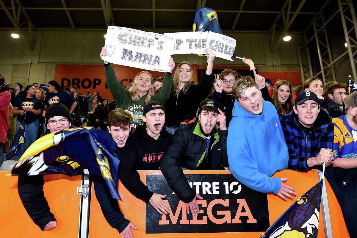 Spectators cheer during the Super Rugby Aotearoa rugby game between the Highlanders and Chiefs in Dunedin, New Zealand, Saturday, June 13, 2020. Super Rugby Aotearoa is the first major rugby union tournament to resume since the COVID-19 outbreak and one of the first major sports events in the world at which there will be no limitation on crowd size. (Joe Allison /Photosport via AP)