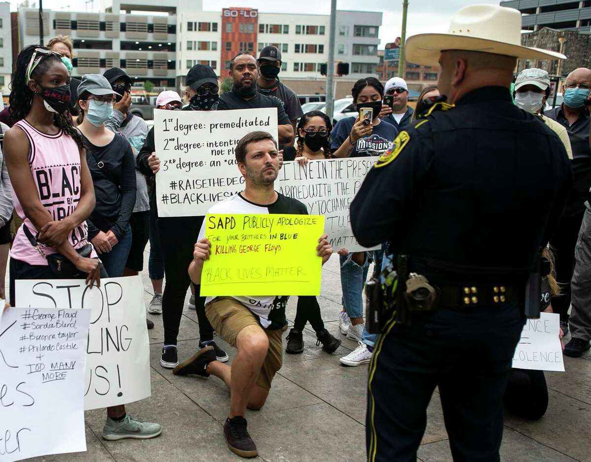 Bexar County Sheriff Javier Salazar speaks to protesters outside of the Bexar County Courthouse in San Antonio on June 1, 2020. At left are activists Valerie Reiffert and kneeling is Brandon Mowles. George Floyd died in the custody of the Minneapolis Police Department and his death on May 25 has sparked protests across the country calling for justice for his death.