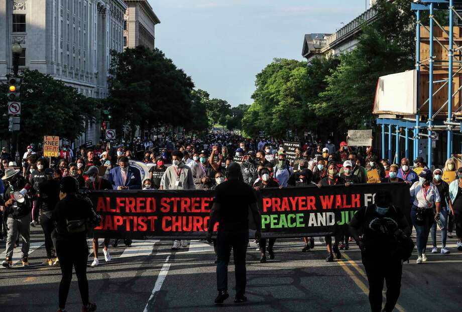Hundreds march from the National Museum of African American History & Culture to Black Lives Matter Plaza across the street from the White House as part of, Prayer Walk for Peace & Justice, organized by Alfred Street Baptist Church and the NAACP on June 14. Photo: Photo For The Washington Post By Oliver Contreras / Oliver Contreras