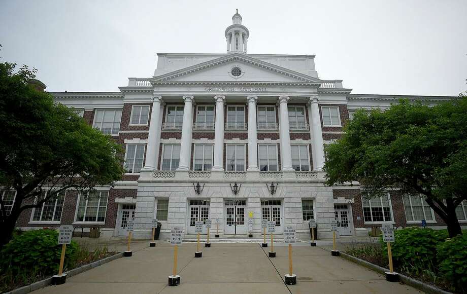 Signs of reminder for visitors, on Social Distancing rules, Stay 6 feet Apart, are posted in front of the Greenwich Town Hall on June 11, 2020 in Greenwich, Connecticut. Photo: File / Matthew Brown / Hearst Connecticut Media / Stamford Advocate