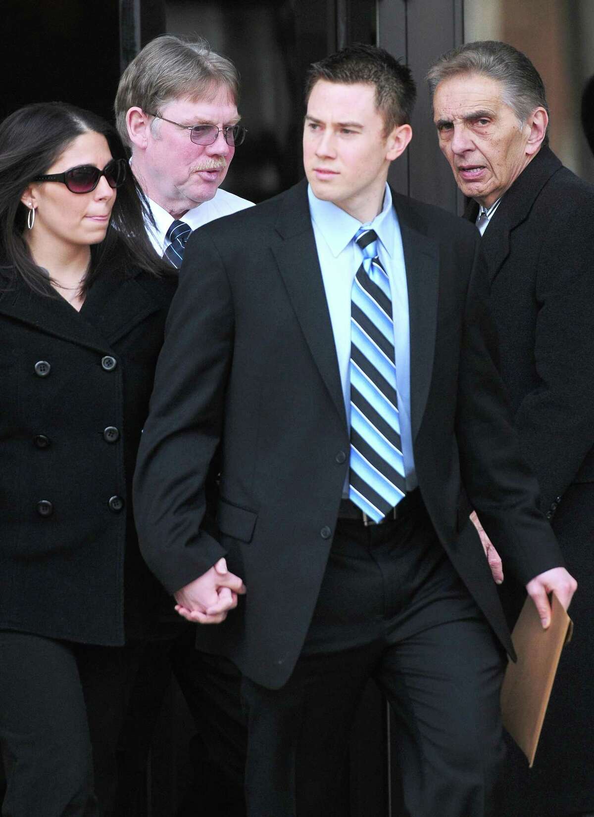 East Haven Police Officer Dennis Spaulding (second from right) walks out of U.S. District Court in Bridgeport after a bail hearing on 2/14/2012. Photo by Arnold Gold/New Haven Register AG0439D