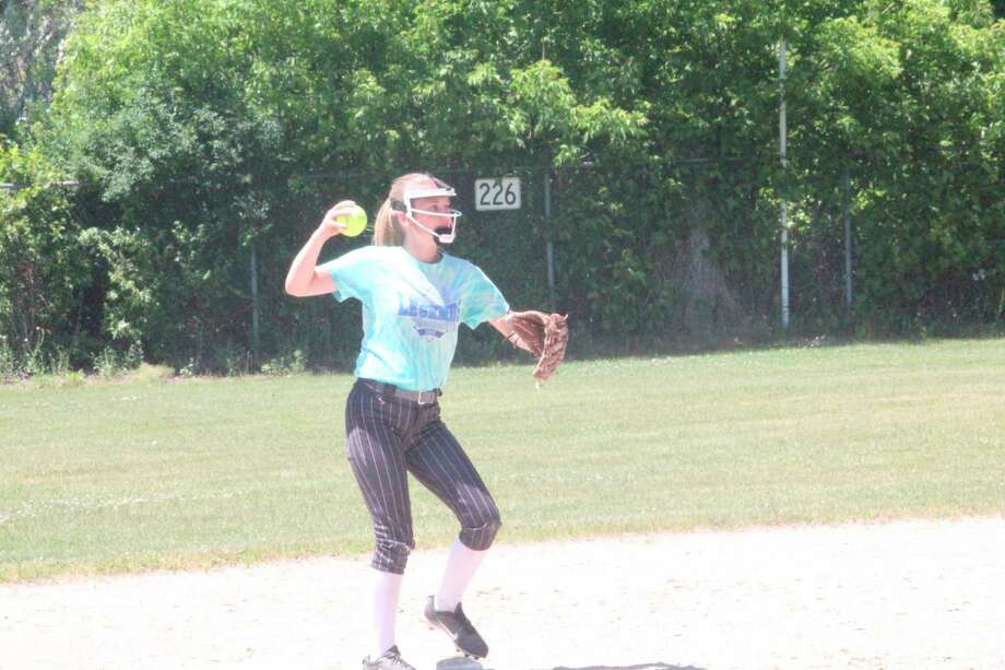 Evart's Lillie Gallinger of the Michigan Expos gets set to make the throw during a practice session at Vogel Field on Sunday. (Pioneer photo/John Raffel)