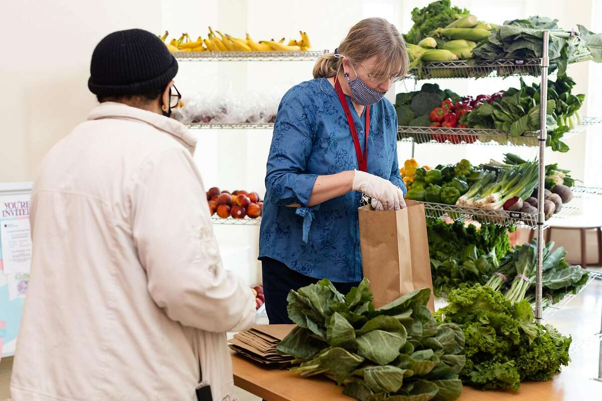 Cathy Davis, executive director of Bayview Senior Services, prepares a food bundle on Friday, June 12, 2020, in San Francisco, Calif.