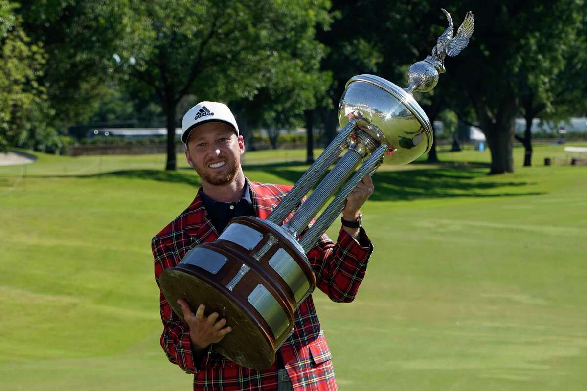 Daniel Berger poses with the championship trophy after winning the Charles Schwab Challenge golf tournament after a playoff round at the Colonial Country Club in Fort Worth, Texas, Sunday, June 14, 2020. (AP Photo/David J. Phillip)