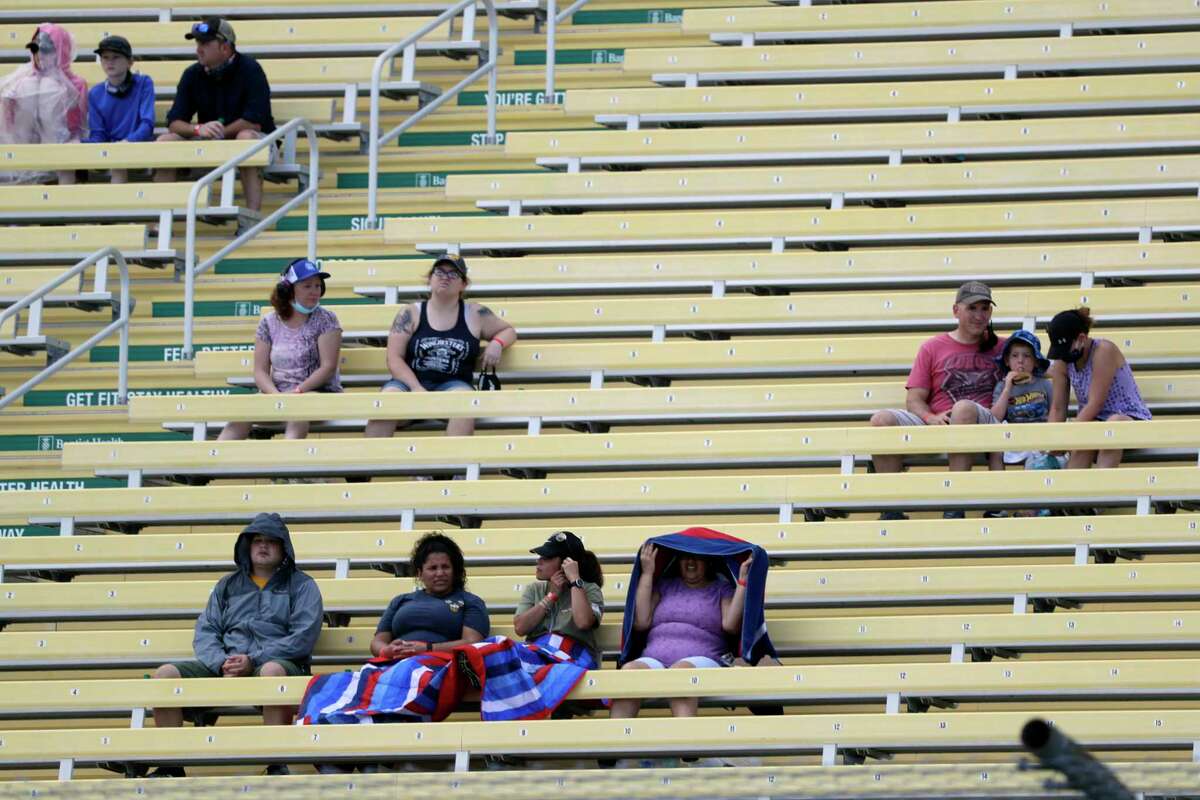 Fans wait for the start of a NASCAR Cup Series auto race Sunday, June 14, 2020, in Homestead, Fla. Up to 1,000 area military members and guests were allowed in to watch the race. (AP Photo/Wilfredo Lee)