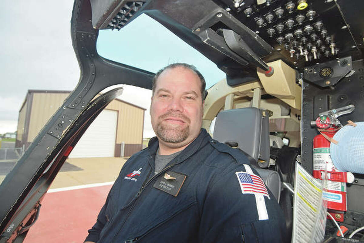 Pilot Joshua DeGrave sits in the cockpit of the Air Evac helicopter.