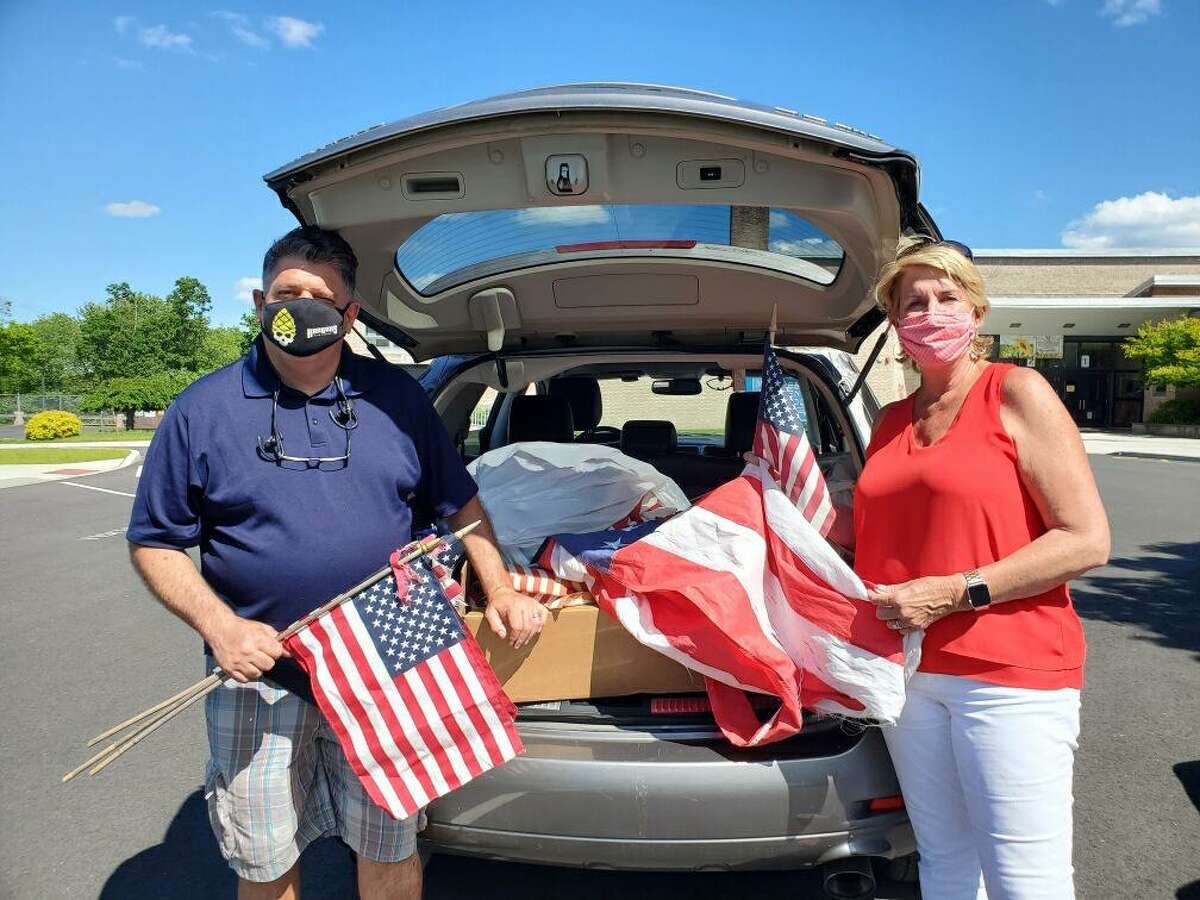 State Reps. Dave Rutigliano (R-123) and Laura Devlin (R-134) are standing in front of a car full of worn and tattered flags collected on Saturday, June 13, during their fourth annual flag collection, in cooperation with the Trumbull American Legion Post #141. For this year's flag collection, the lawmakers observed social distancing practices with a car drop-off at Middlebrook Elementary School. The flags will be given to the American Legion for proper retirement.