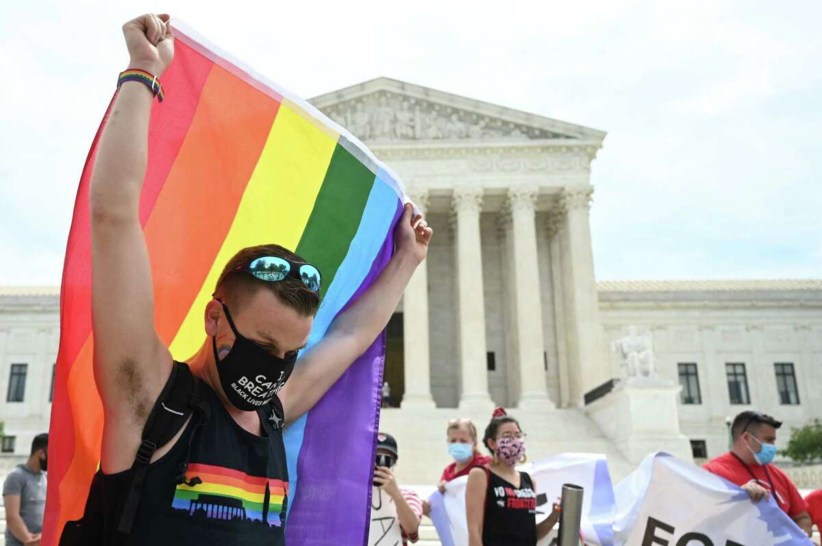 A man waves a rainbow flag in front of the US Supreme Court that released a decision that says federal law protects LGBTQ workers from discrimination on June 15, 2020 in Washington,DC. - The US top court has ruled it illegal to fire workers based on sexual orientation. (Photo by JIM WATSON / AFP) (Photo by JIM WATSON/AFP via Getty Images)