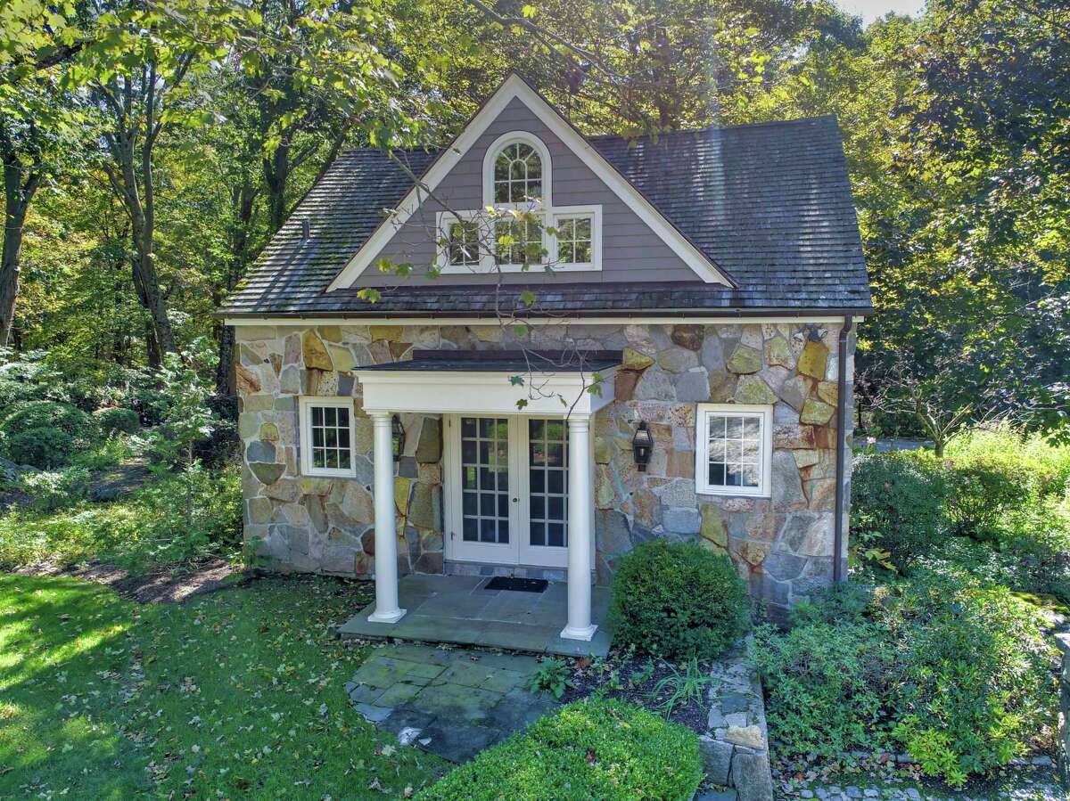 There are several outbuildings including the two-story, free-standing guest house with stone that matches the main residence. There is a staff apartment above the attached three-car garage with its own entrance and it includes a bedroom, living room, kitchen and full bath; perhaps an in-law or au pair suite.