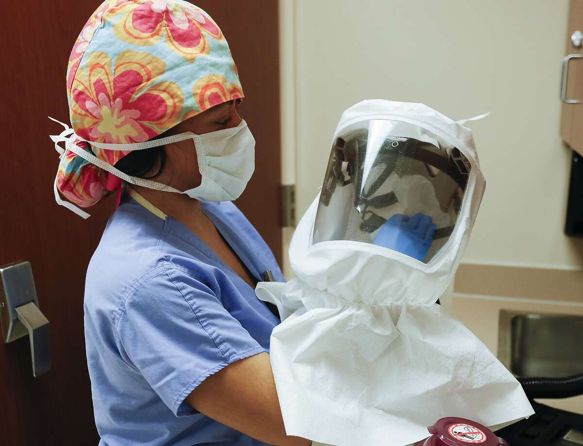 Halle Trujillo, a repertory therapist with Houston Methodist's Highly Infectious Disease Unit, cleans personal protective equipment at Houston Methodist Continuing Care Hospital, Tuesday, May 5, 2020, in Katy.