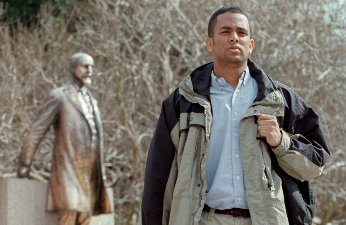 In this 2002 photograph, Bereket Bisrat, spokesman for A&M's African-American Student Coalition at the time, walks past the statue of former A&M President Sul Ross on the College Station campus.
