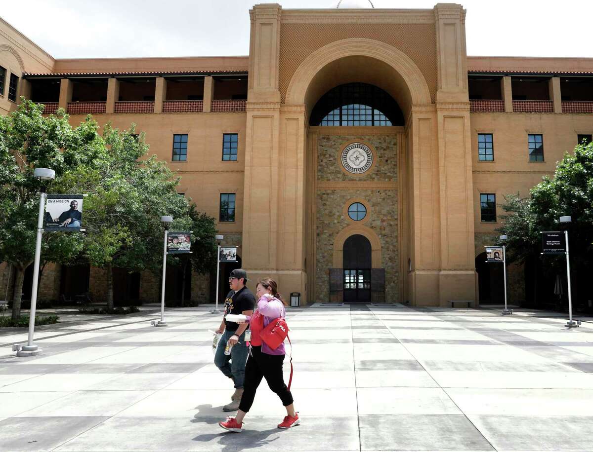 Ivan Naranjo and Gisel Covarrubias, walk back to their Esperanza Hall at Texas A&M University San Antonio, as they chose to stay in the dorm instead of going to their families' home in Robstown, on Tuesday, April 21, 2020.
