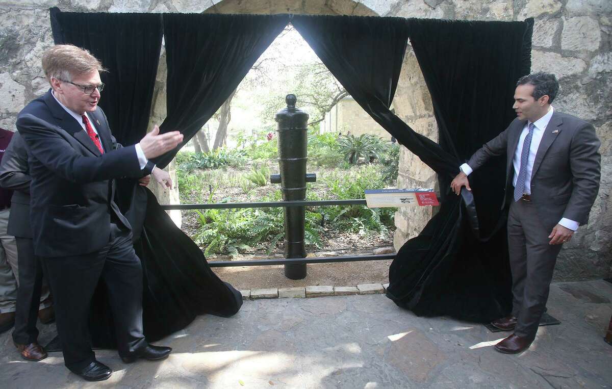 Texas Lt. Govenor Dan Patrick (left) and Texas Land Commissioner George P. Bush (right) unveil a late 18th Century cannon that was recently placed at the Alamo after being restored by Texas A&M University. This cannon is one of two that were restored and unveiled as a part of the celebration held to honor Texas Independence Day.