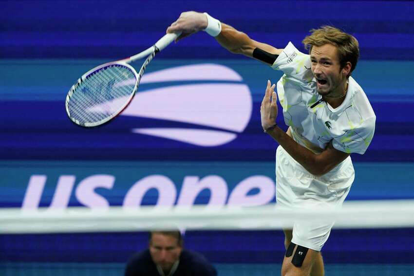 FILE - In this Sept. 6, 2019, file photo, Daniil Medvedev, of Russia, serves to Grigor Dimitrov, of Bulgaria, during the men's singles semifinals of the U.S. Open tennis championships in New York. The U.S. Tennis Association intends to hold the U.S. Open Grand Slam tournament in New York starting in August without spectators, if it gets governmental support -- and a formal announcement could come this week.(AP Photo/Eduardo Munoz Alvarez, File)