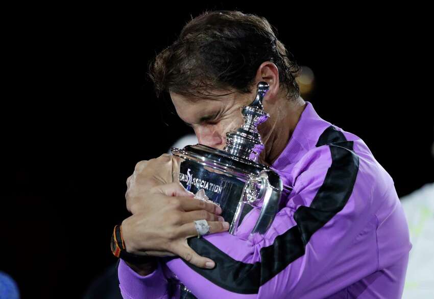 FILE - In this Sept. 8, 2019, file photo, Rafael Nadal, of Spain, hugs the trophy after defeating Daniil Medvedev, of Russia, to win the men's singles final of the U.S. Open tennis championships in New York. The U.S. Tennis Association intends to hold the U.S. Open Grand Slam tournament in New York starting in August without spectators, if it gets governmental support -- and a formal announcement could come this week. (AP Photo/Adam Hunger, File)