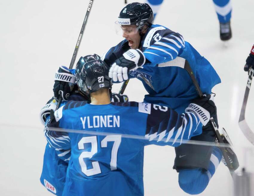 FILE - In this Jan. 5, 2019, file photo, Finland's Oskari Laaksonen jumps into the arms of Jesse Ylonen celebrating Ylonen's goal during the second period of the gold medal game at the world junior hockey tournament against the United States, in Vancouver, British Columbia. The Buffalo Sabres signed defenseman Oskari Laaksonen to a three-year entry-level contract on Monday, June 15, 2020. Laaksonen was Buffalo's third-round pick in the 2017 draft and spent the past two-plus seasons playing in Finland's Elite League. (Jonathan Hayward/The Canadian Press via AP, File)
