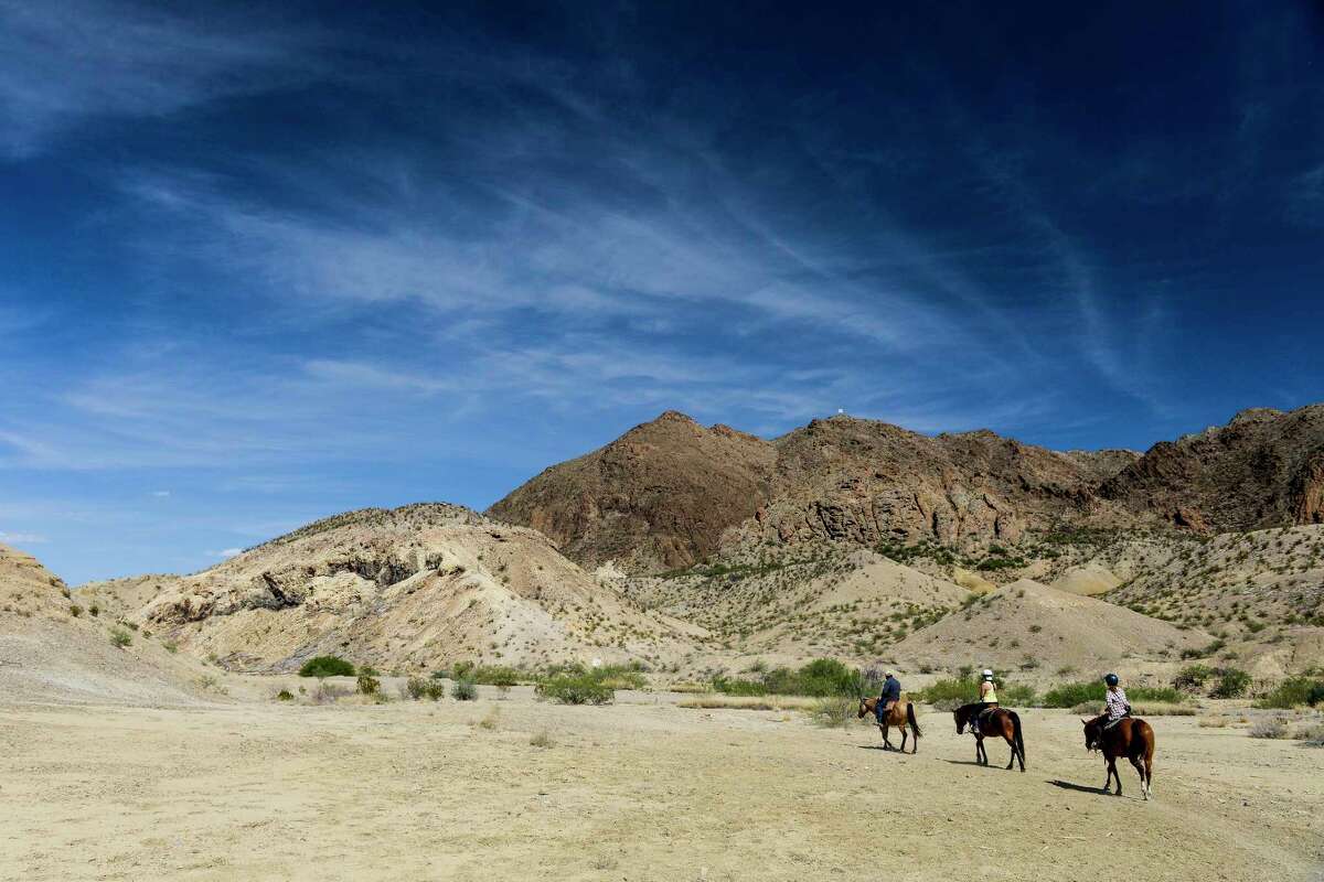 Big skies and horses are part of the myth of Texas. Horseback riders pass through Rough Run Creek outside Big Bend National Park