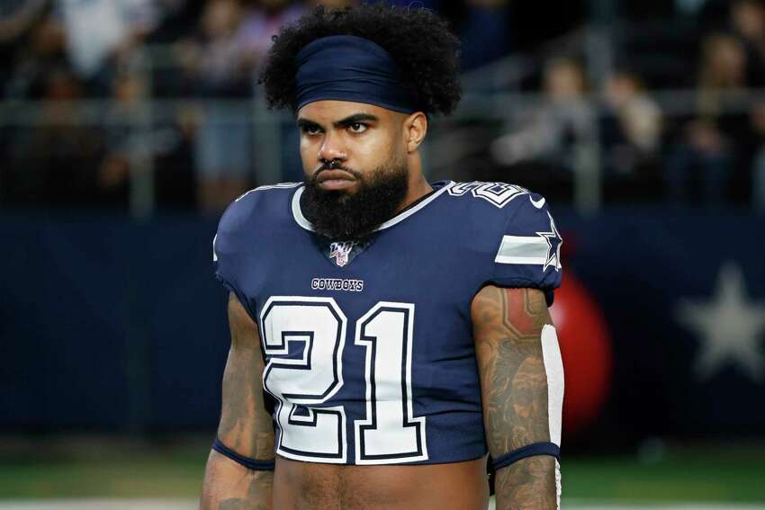 FILE - In this Dec. 15, 2019, file photo, Dallas Cowboys running back Ezekiel Elliott (21) warms up before an NFL football game against the Los Angeles Rams in Arlington, Texas. Ezekiel Elliott tested positive for the coronavirus, according to his agent. Rocky Arceneaux told the NFL Network on Monday, June 15, 2020, that Elliott was feeling OK and recovering.(AP Photo/Roger Steinman, FIle)