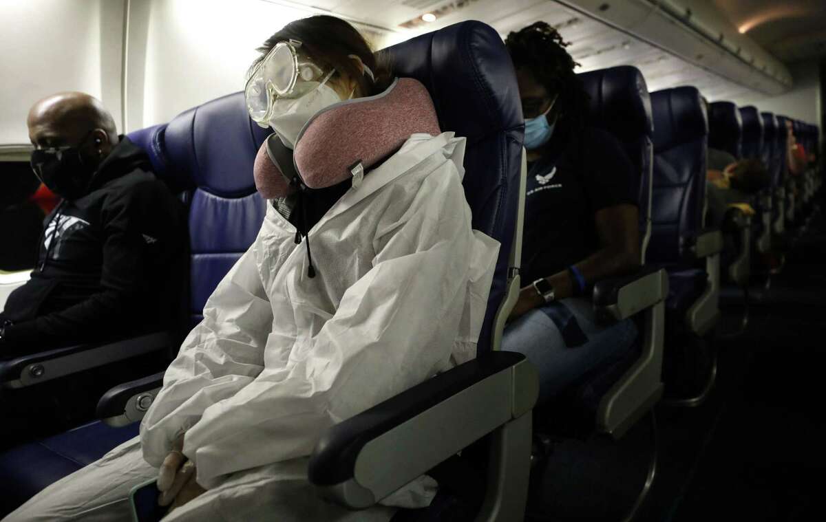 A passenger wears personal protective equipment (PPE) while aboard a Southwest Airlines flight from Los Angeles, California to Houston, Texas on June 7, 2020. All passengers were required to wear face coverings and middle seats were left unoccupied to allow for social distancing.