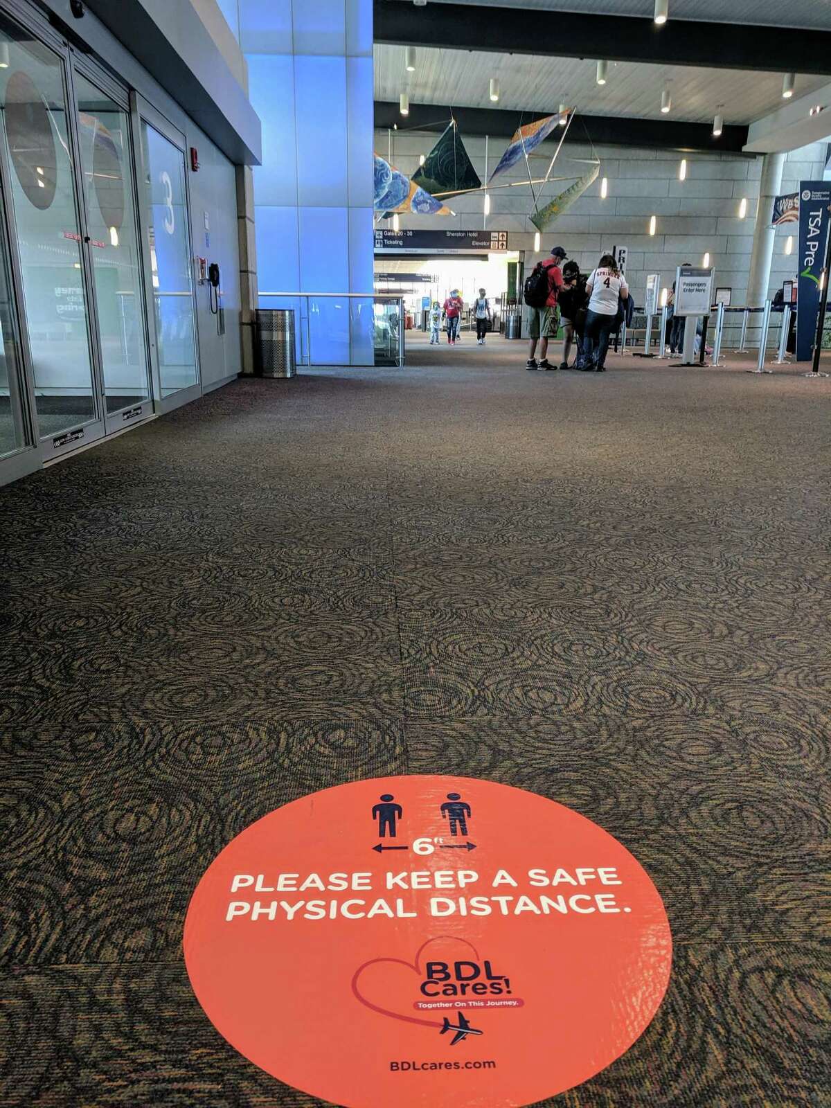 With passengers gradually returning to Bradley International Airport in Windsor Locks, Conn., there are new measures in place to keep travelers safe in the age of the coronavirus pandemic. To remind everyone to keep a safe physical distance from other individuals, the airport has installed floor markings and other graphics throughout the terminal.