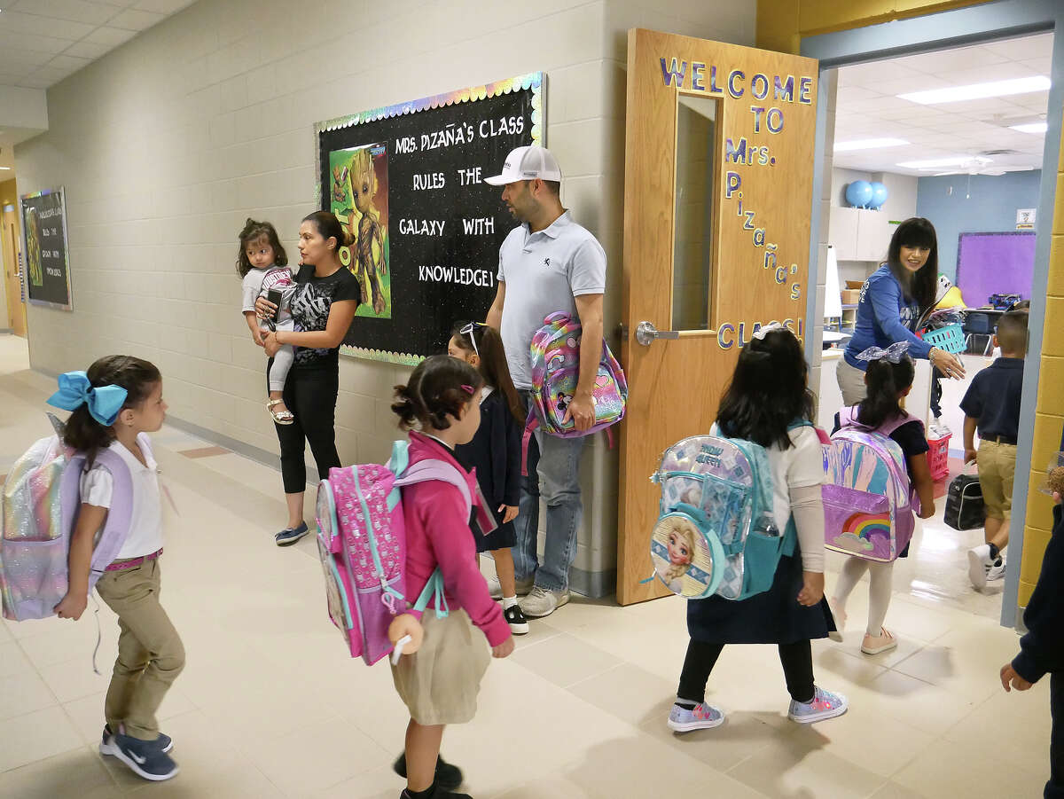 Parents look on as students walk into their classroom for the first day of the 2019-2020 school year at Octavio Salinas Elementary, Wednesday, August 14, 2019.