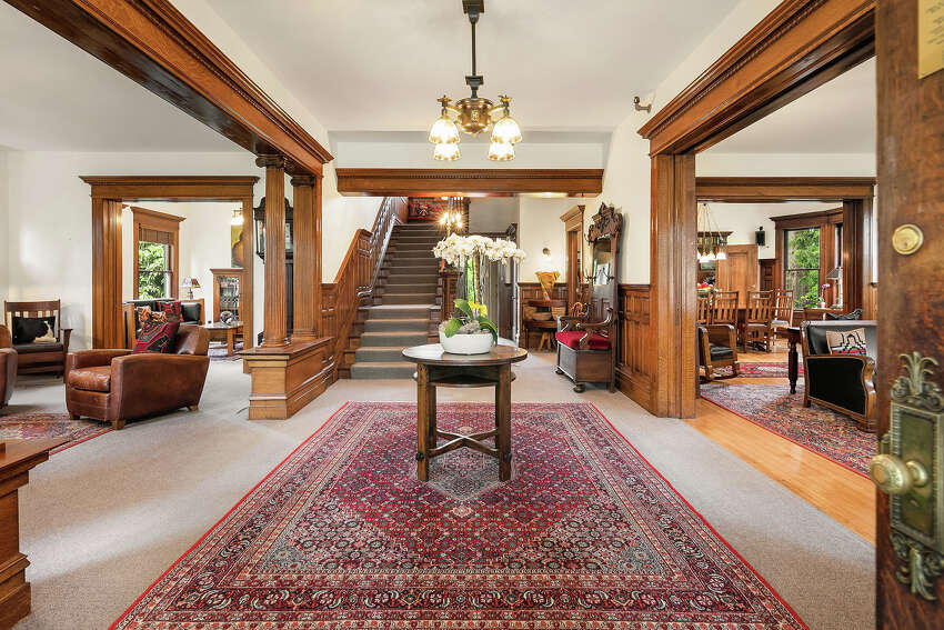 The 凯发k8地址home has been exquisitely restored as a bed and breakfast that could once again be a grand single-family abode. Here we see the oak millwork and ornate bannister and windows.